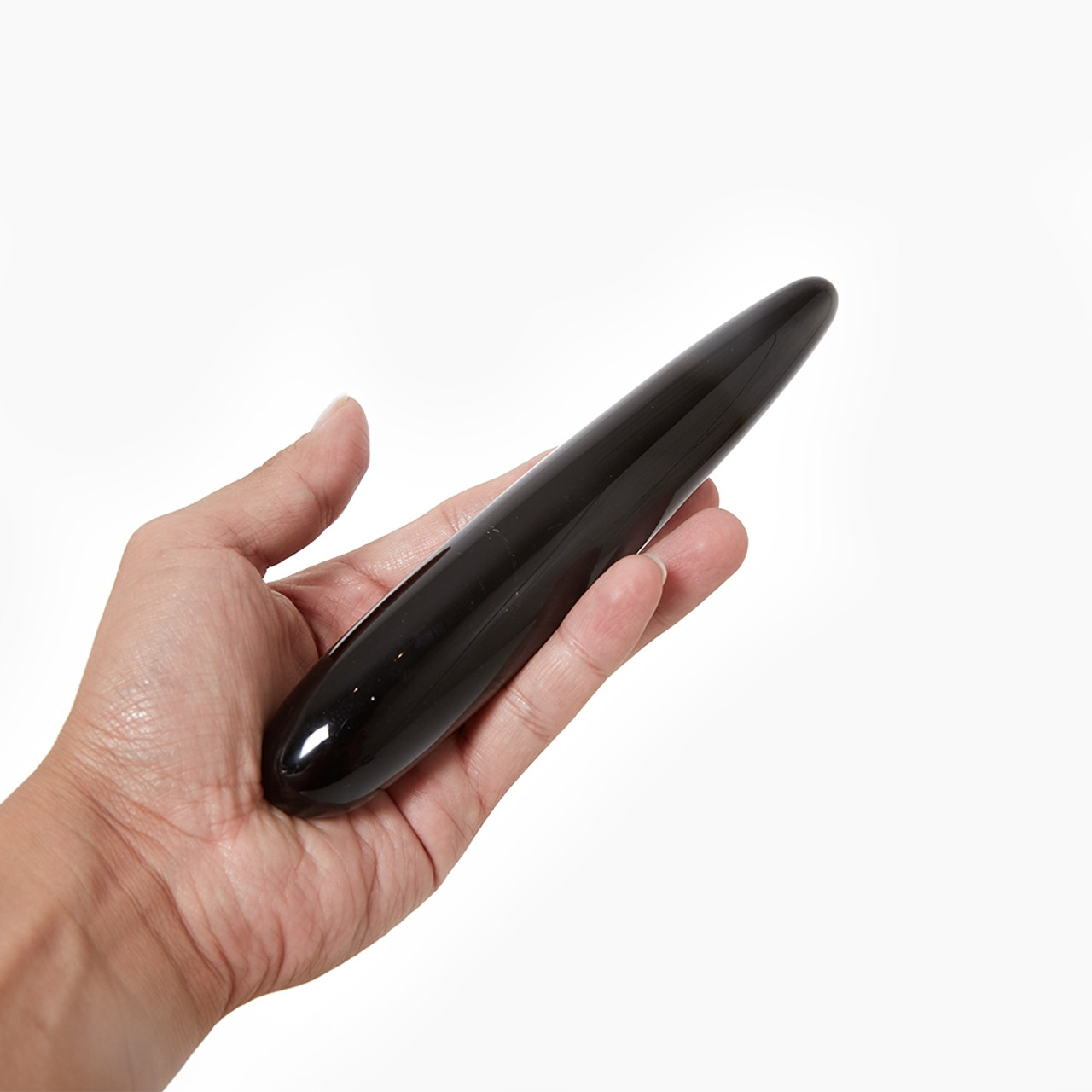 The Xaga Slim Crystal Dildo held in a hand