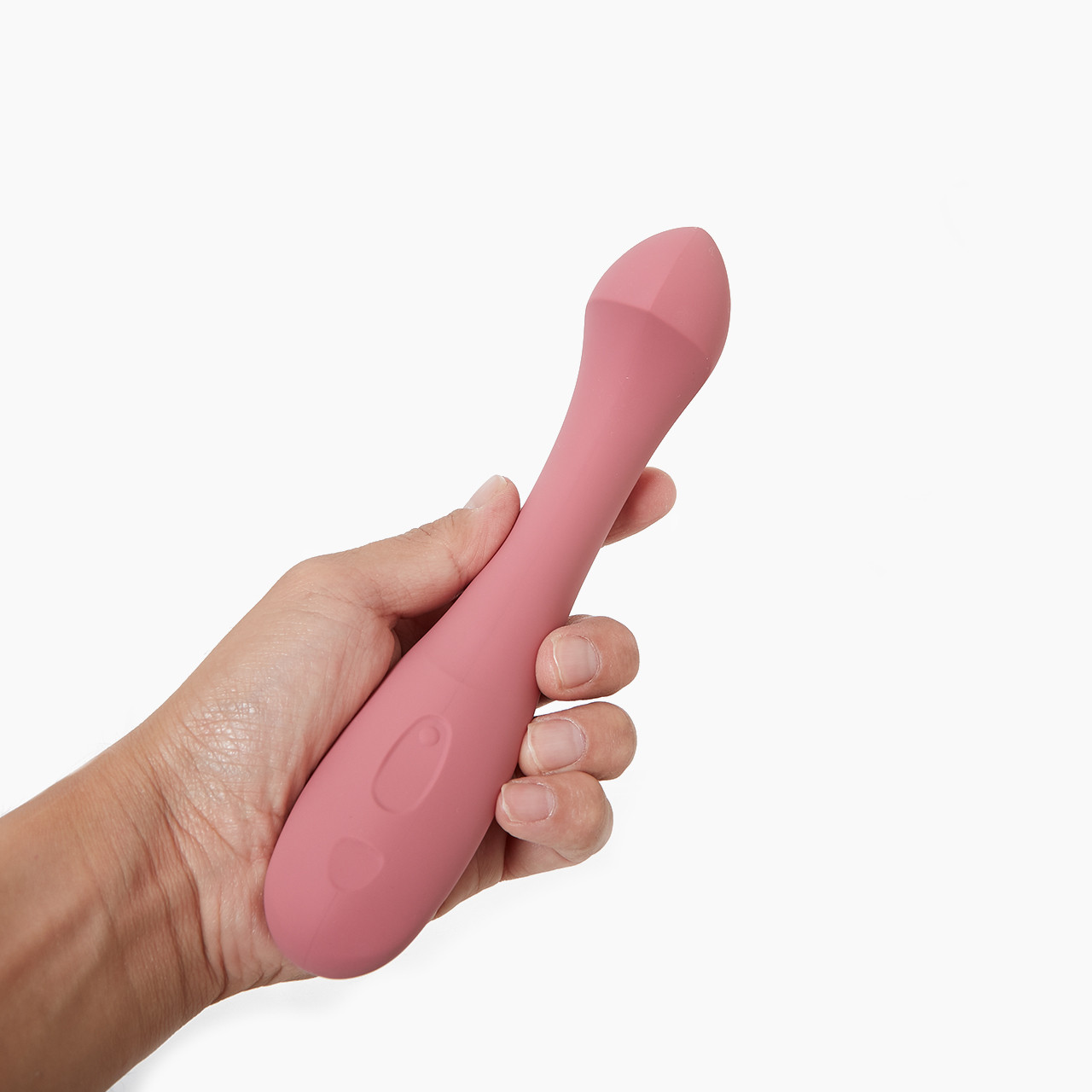 'Dame Arc', a pink silicone massager held in a hand, against a white background