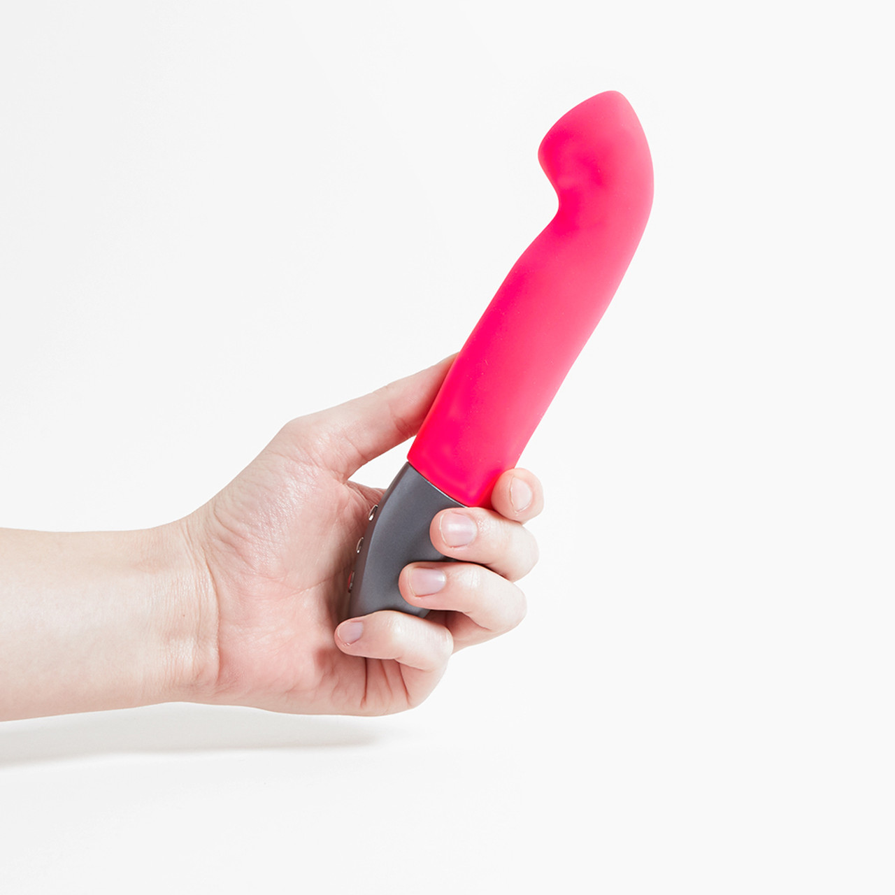 Fun Factory Stronic G', a bright pulsator with a grey handle held in a hand, against a white background 