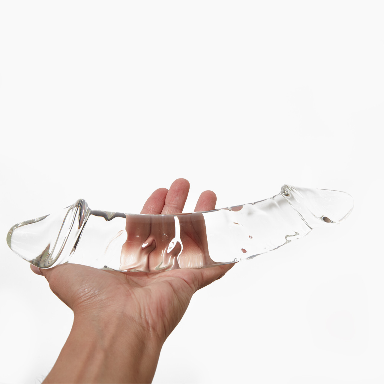 'Glas 10.5" Girthy Double Dong', a transparent double-ended glass massager held in a hand