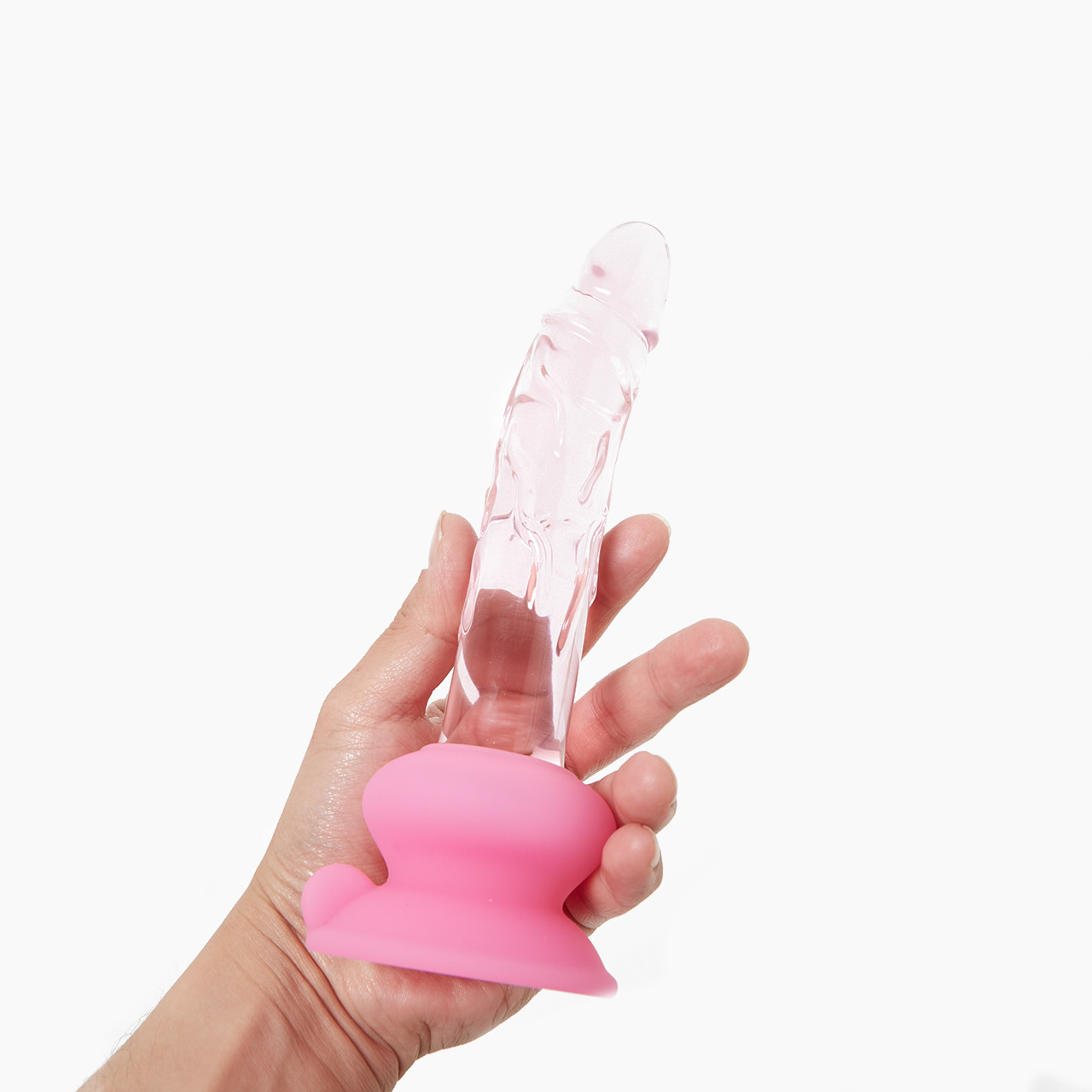 Hand holding a clear, textured Icicles No. 86 glass dildo