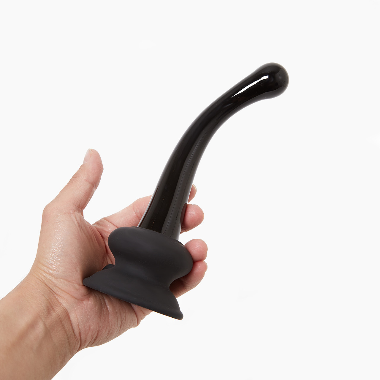 Hand presenting 'Icicles Curved Glass G-Spot Dildo', a black glass toy with a curved tip