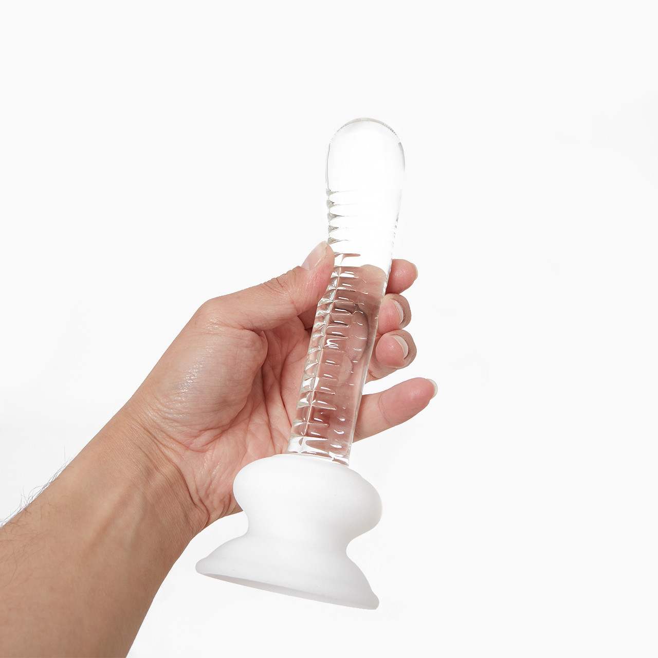Icicles No. 88 G-Spot Ridged Glass Dildo' with a clear ribbed texture and a white base held in a hand