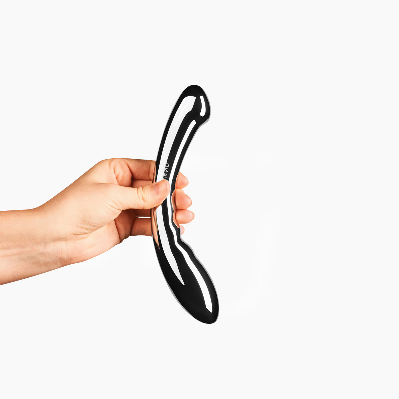 'Le Wand Arch', a curved personal massager held in a hand against a white background