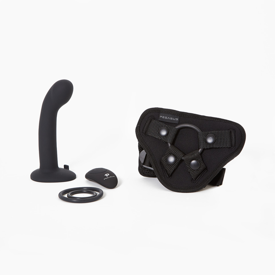 A black P & G-spot dildo with a flared base next to a harness and remote control