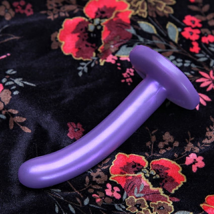 Tantus Silk Small on a floral patterned silk material